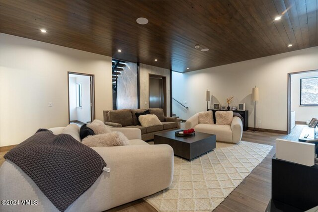 living room with wood ceiling and light hardwood / wood-style flooring