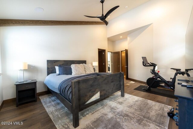 bedroom featuring ceiling fan, a towering ceiling, and dark hardwood / wood-style flooring