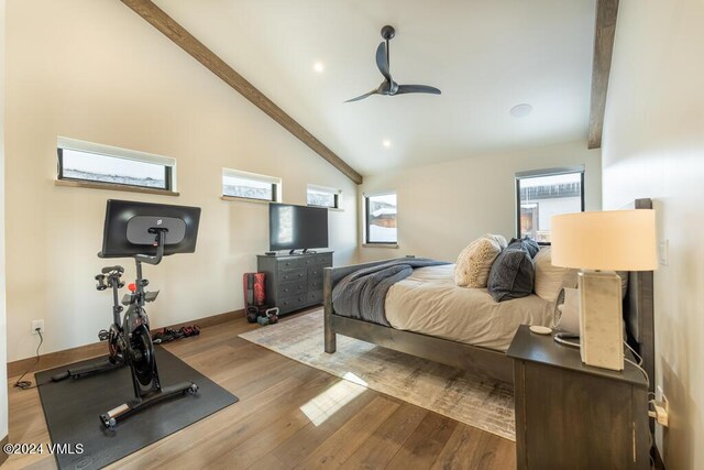 bedroom featuring ceiling fan, lofted ceiling with beams, and light hardwood / wood-style flooring