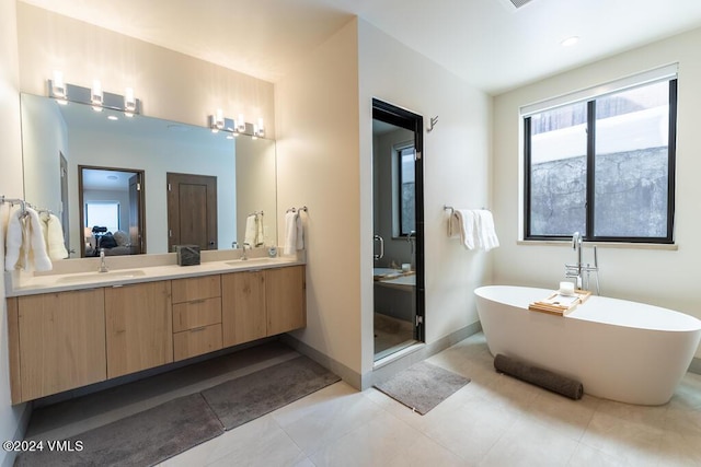 bathroom featuring vanity, shower with separate bathtub, and tile patterned flooring