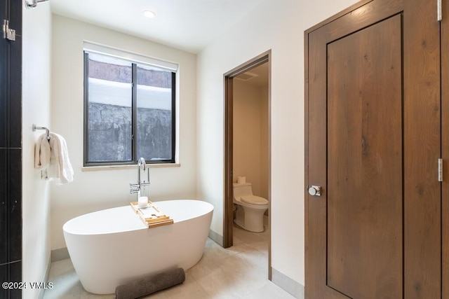 bathroom featuring a bathtub and toilet