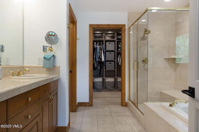 220 Singletree Rd, Edwards, CO 81632 - bathroom featuring vanity, a stall shower, a garden tub, a walk in closet, and tile patterned floors
