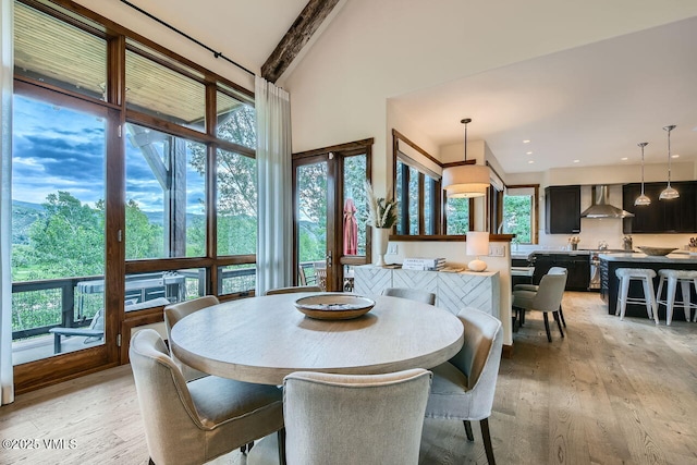 44 Conestoga Cir, Edwards, CO 81632 - dining room featuring light wood finished floors, healthy amount of natural light, beam ceiling, a high ceiling, and recessed lighting