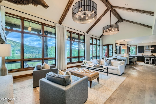 44 Conestoga Cir, Edwards, CO 81632 - living room with high vaulted ceiling, a chandelier, light wood-style flooring, and beam ceiling