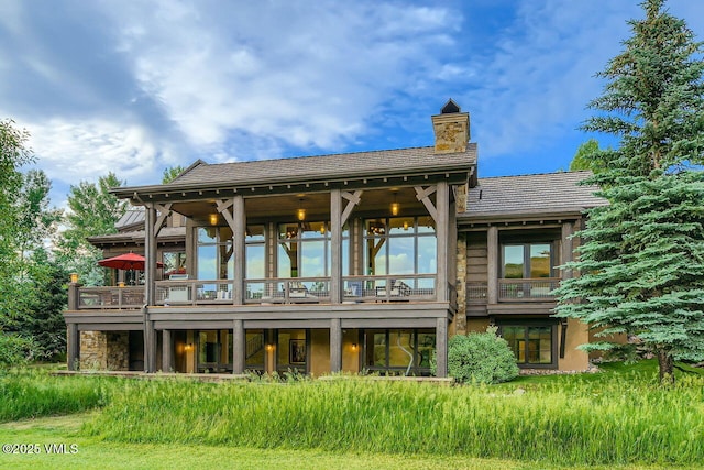 44 Conestoga Cir, Edwards, CO 81632 - rear view of house with a chimney and a deck