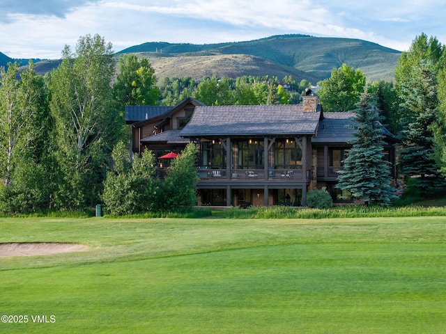 44 Conestoga Cir, Edwards, CO 81632 - back of property with a yard, a chimney, and a deck with mountain view