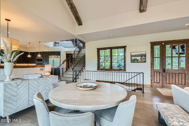 44 Conestoga Cir, Edwards, CO 81632 - dining area featuring stairs, beamed ceiling, light wood-style flooring, and a high ceiling