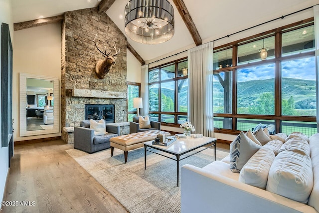 44 Conestoga Cir, Edwards, CO 81632 - living area featuring wood finished floors, high vaulted ceiling, beamed ceiling, and a stone fireplace