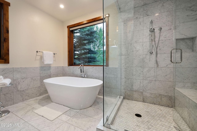 44 Conestoga Cir, Edwards, CO 81632 - bathroom with tile walls, a shower stall, a freestanding bath, wainscoting, and recessed lighting