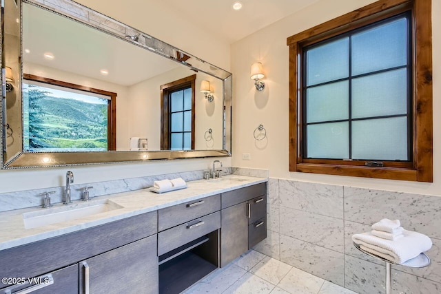 44 Conestoga Cir, Edwards, CO 81632 - full bath featuring double vanity, tile patterned flooring, recessed lighting, and a wainscoted wall
