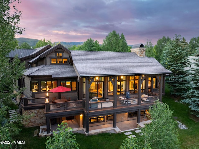44 Conestoga Cir, Edwards, CO 81632 - rear view of house featuring a patio area, a chimney, and a balcony