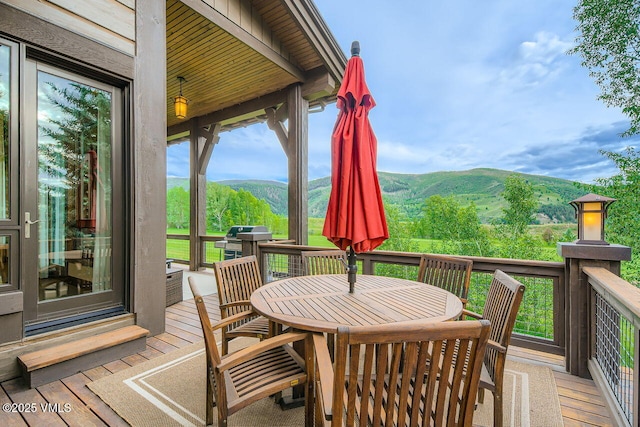 44 Conestoga Cir, Edwards, CO 81632 - wooden deck with a mountain view, outdoor dining space, and a grill