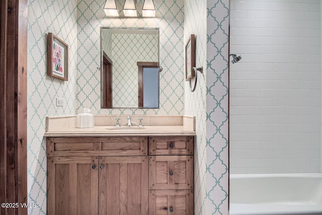 44 Conestoga Cir, Edwards, CO 81632 - bathroom featuring wallpapered walls, vanity, and shower / tub combination