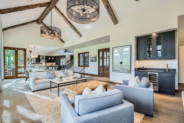 44 Conestoga Cir, Edwards, CO 81632 - living area featuring beverage cooler, beamed ceiling, high vaulted ceiling, light wood-type flooring, and bar with sink