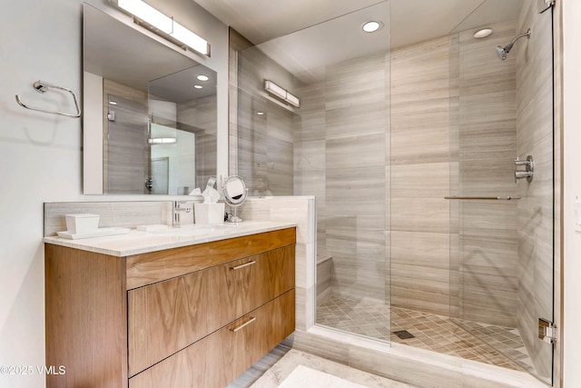 full bathroom with a stall shower and vanity