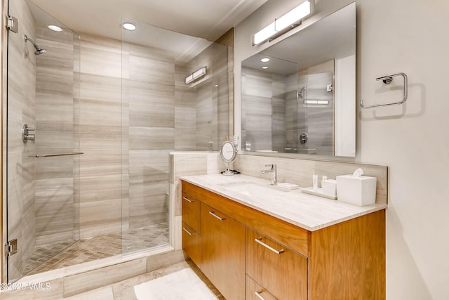 full bath with backsplash, a stall shower, and vanity