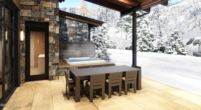 snow covered patio featuring a hot tub