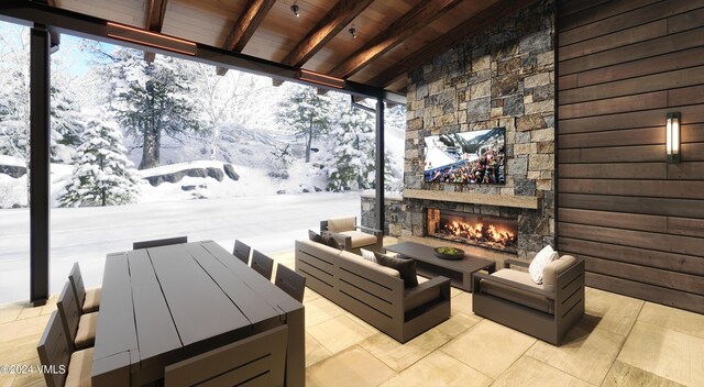 snow covered patio with an outdoor living space with a fireplace