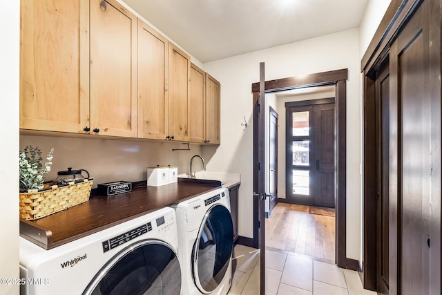 481 Hunters View Ln, Eagle, CO 81631 - laundry area featuring cabinets, light tile patterned flooring, sink, and washing machine and clothes dryer