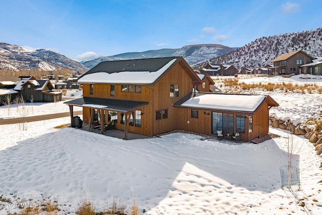 481 Hunters View Ln, Eagle, CO 81631 - snow covered back of property featuring a mountain view
