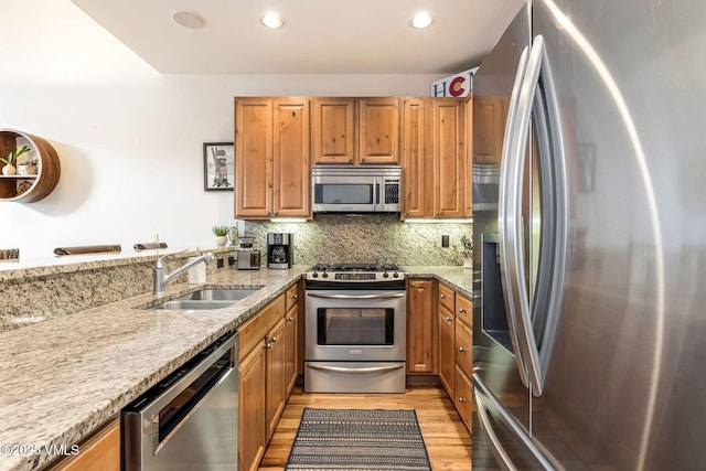 107 Lions Ln, Minturn, CO 81645 - kitchen featuring a sink, backsplash, light stone countertops, and stainless steel appliances