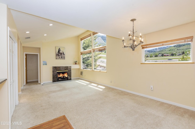 600 Nottingham Rd Unit 8, Avon, CO 81620 - unfurnished living room featuring a chandelier, light colored carpet, baseboards, a high end fireplace, and recessed lighting