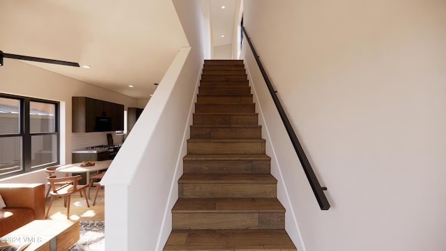 stairway with hardwood / wood-style flooring