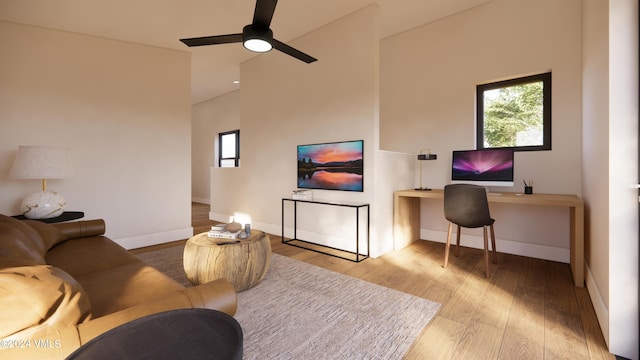 living room with ceiling fan, light hardwood / wood-style flooring, and a healthy amount of sunlight