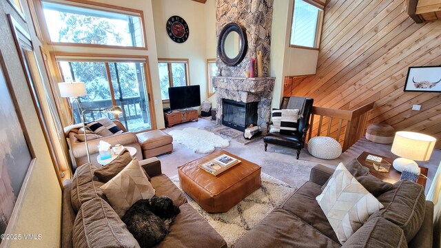 000149 Willis Pl Unit 140, Beaver Creek, CO 81620 - living area with a high ceiling, wood walls, plenty of natural light, and a fireplace