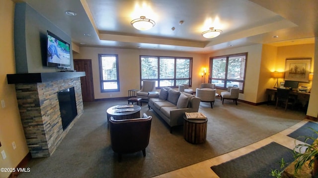 000149 Willis Pl Unit 140, Beaver Creek, CO 81620 - carpeted living room featuring a tray ceiling, baseboards, a fireplace, and plenty of natural light