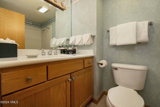 bathroom featuring vanity and toilet