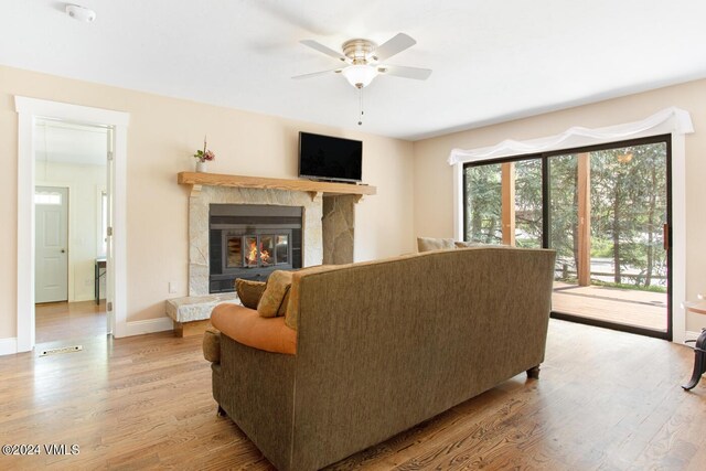 living room with ceiling fan and light wood-type flooring