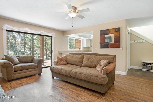 living room featuring ceiling fan and hardwood / wood-style floors