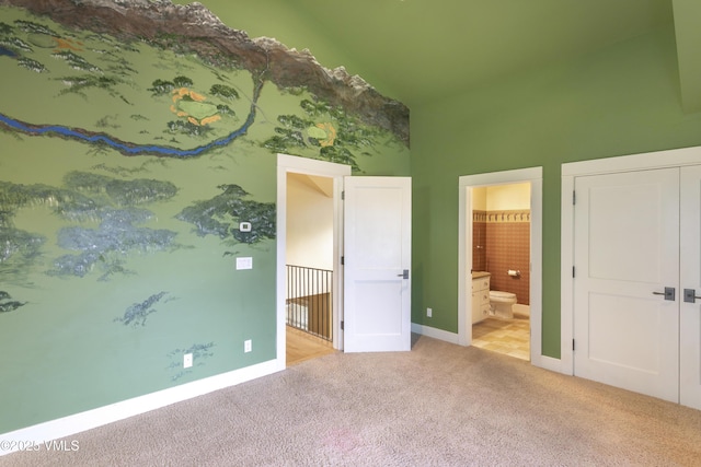 88 E Double Hitch, Eagle, CO 81631 - unfurnished bedroom featuring high vaulted ceiling, light colored carpet, baseboards, and ensuite bath
