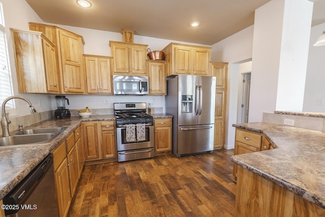 44 Salmon Loop, Gypsum, CO 81637 - kitchen featuring appliances with stainless steel finishes, a sink, dark wood-style flooring, dark countertops, and recessed lighting