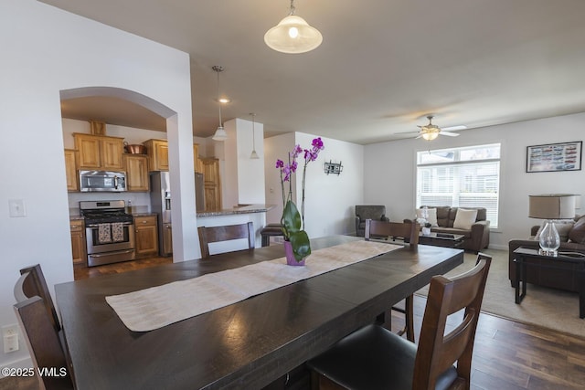 44 Salmon Loop, Gypsum, CO 81637 - dining space featuring a ceiling fan, dark wood finished floors, and arched walkways