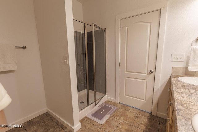 44 Salmon Loop, Gypsum, CO 81637 - full bathroom with vanity, a stall shower, tile patterned floors, and baseboards