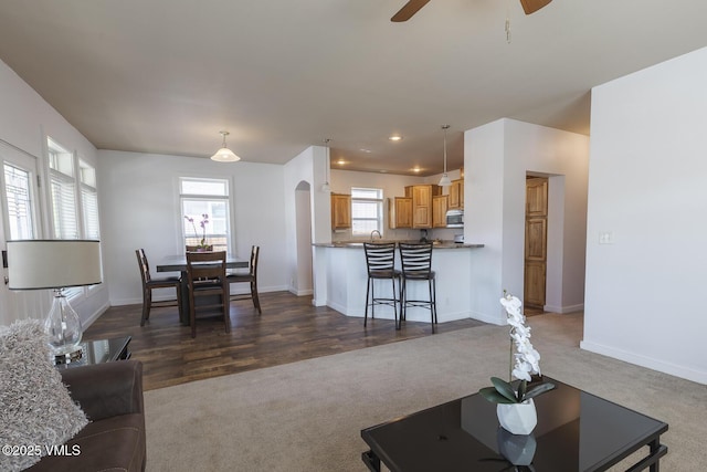 44 Salmon Loop, Gypsum, CO 81637 - living room with dark colored carpet, ceiling fan, baseboards, arched walkways, and recessed lighting