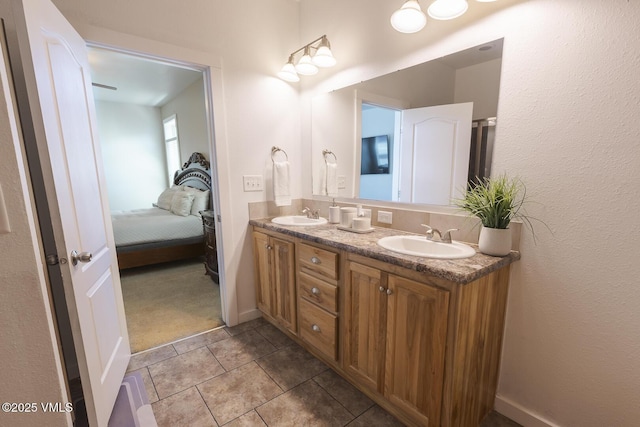 44 Salmon Loop, Gypsum, CO 81637 - full bathroom featuring double vanity, tile patterned flooring, ensuite bathroom, and baseboards