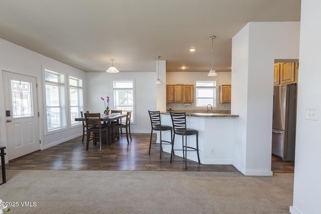 44 Salmon Loop, Gypsum, CO 81637 - kitchen with freestanding refrigerator, dark carpet, baseboards, a sink, and recessed lighting