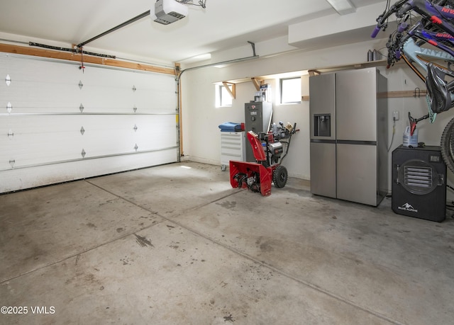 1133 Main St, Minturn, CO 81645 - garage with a garage door opener and stainless steel fridge with ice dispenser