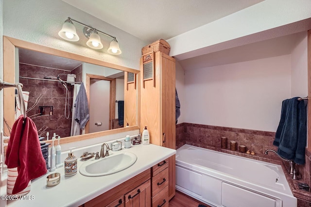 425 Howard St, Eagle, CO 81631 - full bathroom with a garden tub, vanity, and tiled shower