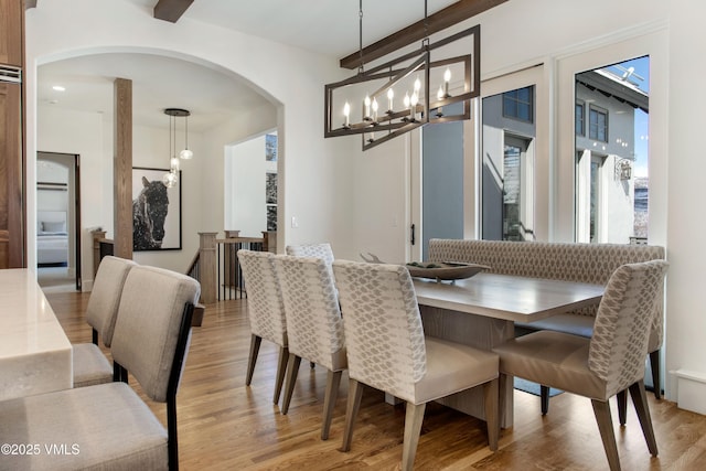446 Kensington Dr, Edwards, CO 81632 - dining room with arched walkways, light wood-style flooring, and a chandelier