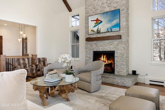446 Kensington Dr, Edwards, CO 81632 - living room with baseboard heating, a fireplace, wood finished floors, high vaulted ceiling, and beamed ceiling