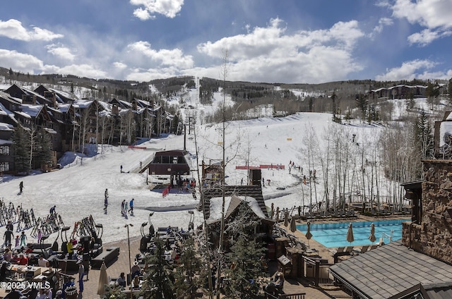 snowy aerial view featuring a mountain view