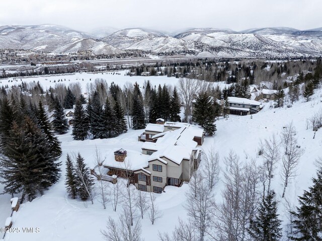 snowy aerial view featuring a mountain view