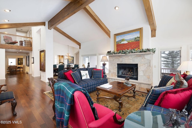 living room with beam ceiling, a chandelier, high vaulted ceiling, dark hardwood / wood-style flooring, and a fireplace