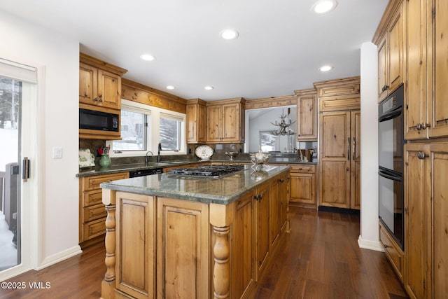 kitchen with tasteful backsplash, a center island, dark stone countertops, dark hardwood / wood-style flooring, and black appliances