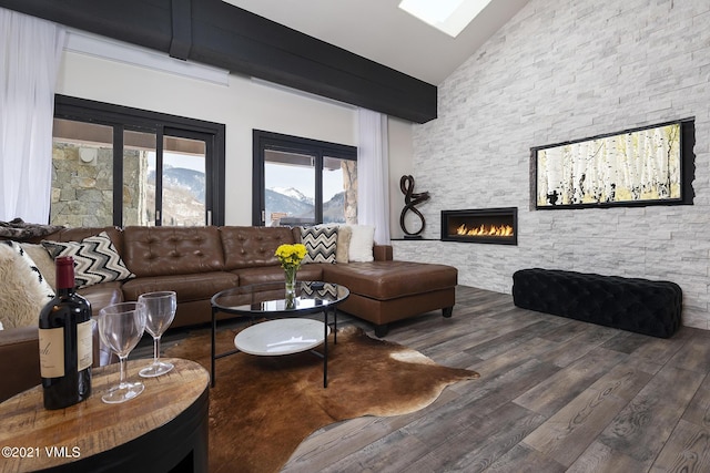 living room featuring hardwood / wood-style flooring, high vaulted ceiling, and a fireplace