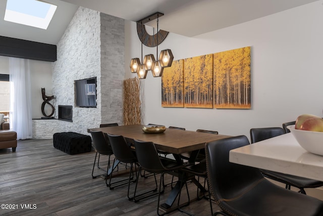 dining area featuring dark hardwood / wood-style floors and high vaulted ceiling